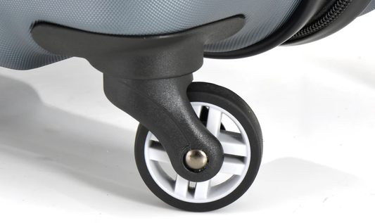 Single spinner wheel mounted on a suitcase.