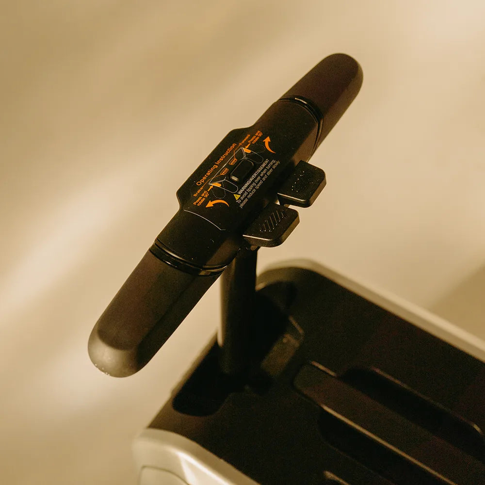 Close-up of the AOTOS L2 dual-grip joystick handlebar featuring intuitive throttle and steering controls for smooth powered travel